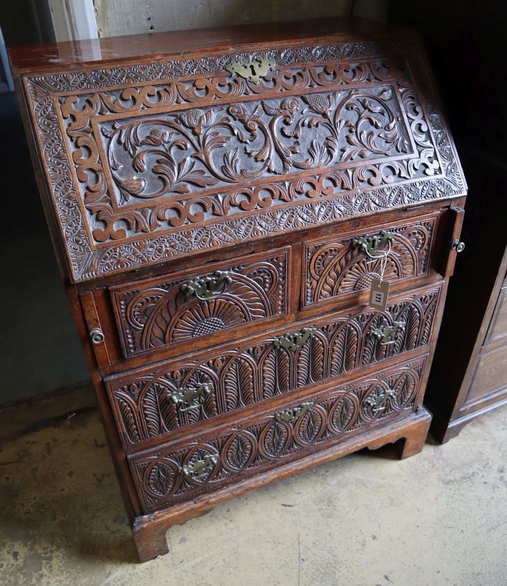 A small 18th century walnut bureau, later carved, width 76cm depth 47cm height 103cm